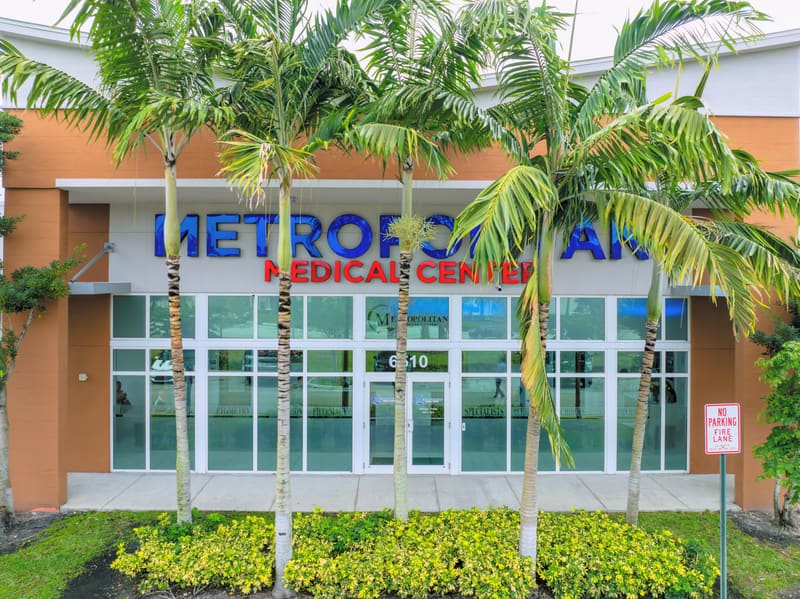 Front of the Metropolitan Medical Center building at 6510 North University Drive, with palm trees