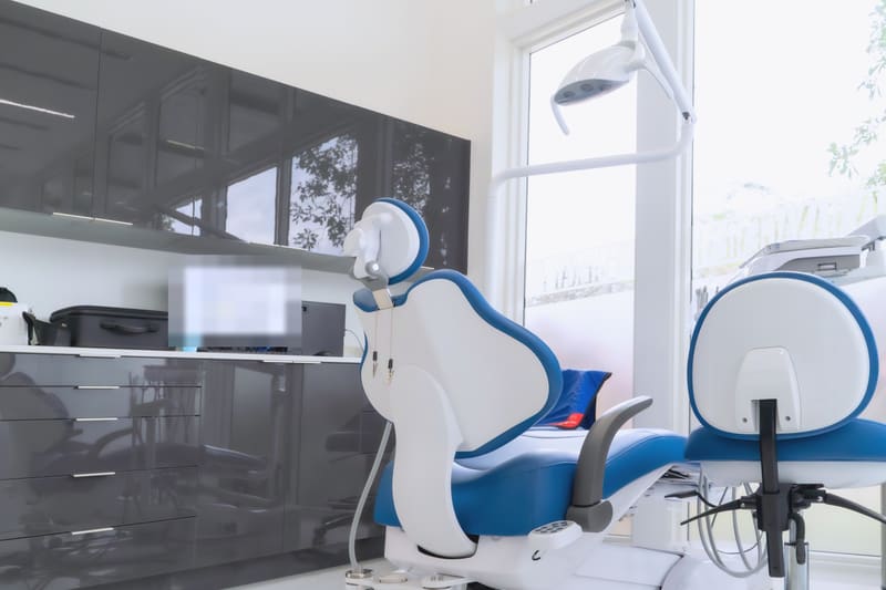 Dental treatment room with two chairs and cabinets