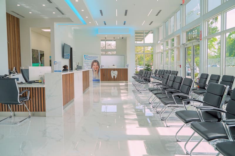 Bright lobby with marble floors, rows of waiting chairs and the front desk