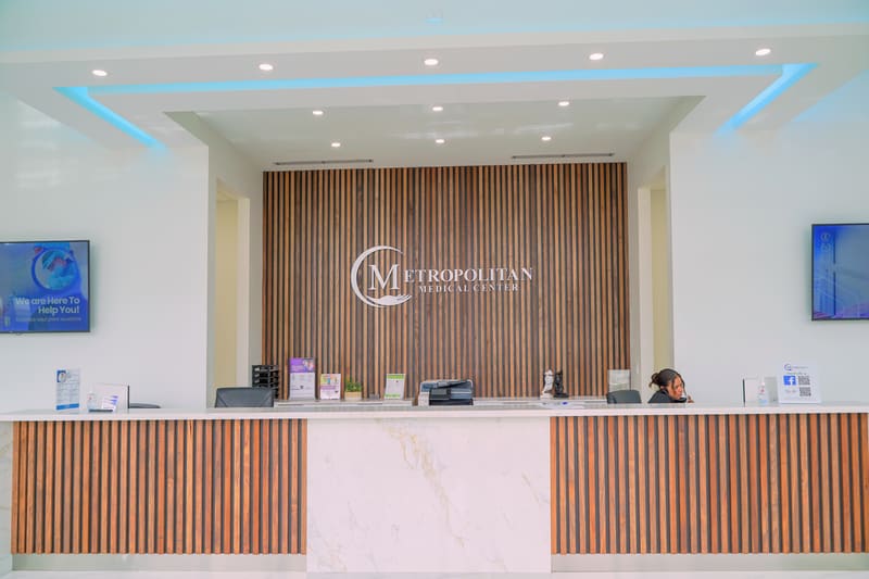 Reception desk with wood slat wall and the Metropolitan logo