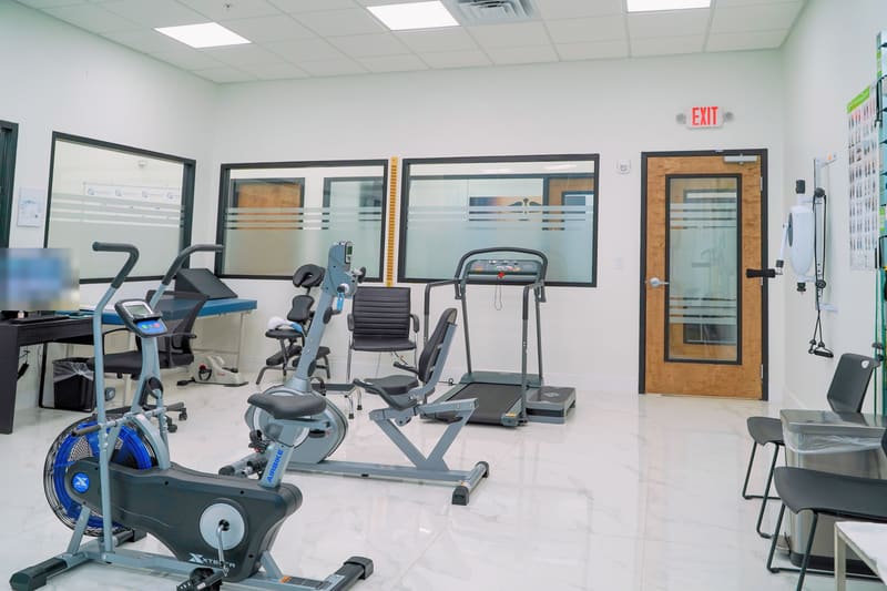 Rehabilitation room with exercise bikes and a treadmill